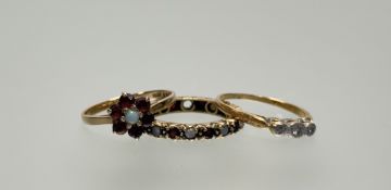 A 9ct gold cluster ring set central opal and six circular cut garnets N 1.4g, a yellow metal