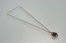 A 9ct gold oval ring framed facet cut cairngorm pendant: l. x 2.5cm on 9ct gold trace link chain