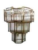 A large contemporary chandelier, in brushed metal finish with three graduated tiers of curved