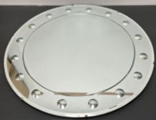 A 20thc Sorcerer style circular mirror, with bevel edge and border of magnified mirrored circles (d.