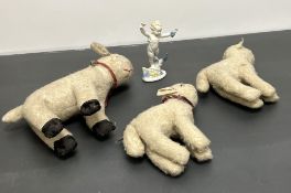 A graduated set of three early 20thc vintage lamb soft toys, constructed from cream wool, the larger