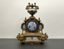 A French Rococo style gilt metal mantle clock with porcelain clock face dial, continental