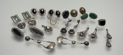 A collection of silver and white metal earrings and rings to include a Russian style five ring