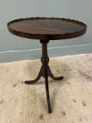 A reproduction mahogany wine table, oval top with scalloped edge on baluster support on tripod base: