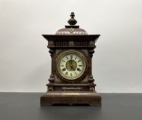 A late 19th/early 20thC mahogany mantle clock, with a brass and enamelled Roman Numeral dial,