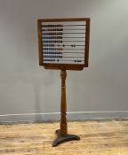 A Victorian pine abacus on a turned tapered column stand (h. 131.5cm)