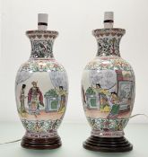 A pair of Chinese Famille Rose Medallion converted vases to table lamps, raised on circular wooden