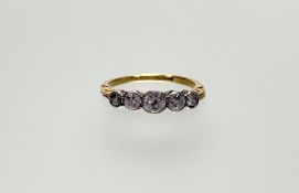 A 1920s yellow metal and white metal mounted five stone graduated old mine cut diamond ring the