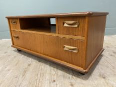 A Mid-century Teak television stand, with open well flanked by two short drawers over one long