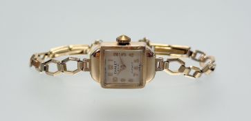A vintage Chalet 9ct gold wristwatch with cream dial and arabic numerals: d. x 1.2cm on 9ct gold