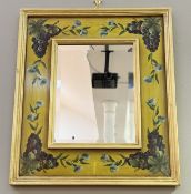 A decorative italian style hand-painted grape vine and blue flower framed hall mirror with
