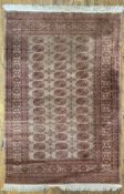 A modern hand-knotted Pakastani Bokhara rug, central panel with three rows of guls enclosed within a