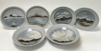 A collection of four Highland Stoneware plates decorated with painted scenes of Scottish lochs and