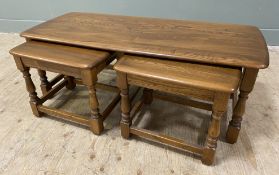 A modern elm set of three nesting tables, by Ercol. Larger table with rectangular top and rounded