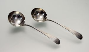 A pair of Georgian London silver sauce ladles engraved with crest and motto - marks heavily