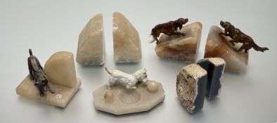 A collection of carved stone bookends comprising, a pair of art deco alabaster bookends with cold