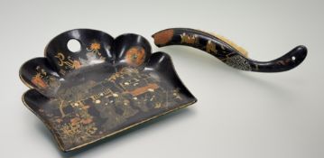 A Chinese black lacqured dust pan and brush, the dust pan with a hand-painted Garden scene with