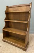 A modern elm kitchen waterfall dresser, by Ercol, with three plate racks to top over open well to
