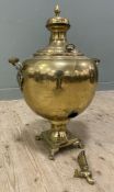 A 20th century Eastern brass samovar, of bulbous form with twin handles to sides raised on