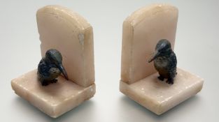 A pair of Art Deco carved alabaster bookends with moulded cold painted Kingfisher figures to