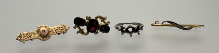 A collection of three brooches to include a gilt metal triple red stone set brooch: l. x 3cm, an
