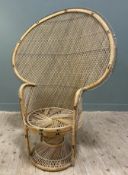 A modern caned peacock chair, large arched back with lattice style design, over a circular seat with