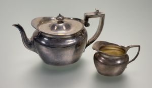 A Victorian silver partial tea service, teapot and cream jug, Goldsmiths’ Alliance, London 1884, the