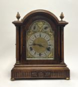 A late Victorian oak bracket clock with brass scroll face by Lenzkirch and with large key, raised on