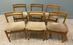 A set of 6 mid century oak dining chairs, curved backs over cushion seats covered in beige seats,