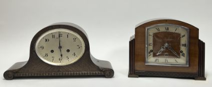 A 1920s oak mantel Napoleon hat mantel clock with carved scroll feet, the circular dial set with