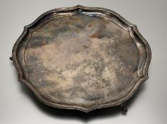 A Edward VII Sheffield silver scalloped drink salver with beaded border on four scroll feet retailed
