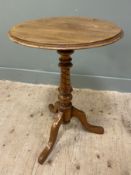 A 19th century mahogany wine table, circular moulded top raised on carved baluster support and a