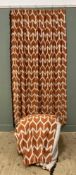 A pair of bold contemporary lined curtains, pencil pleat tops with burnt orange Ikat-style fabric,