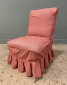 A Victorian slipper chair, with cushioned back and seat covered in soft red geometric slip cover and