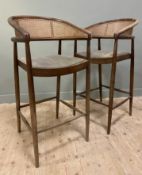 A pair of contemporary oak-framed bar stools, arched backs and bergere rattan sides over forest