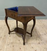 An Edwardian oak sewing table, rectangular mould top pivoting to reveal lined interior, raised on