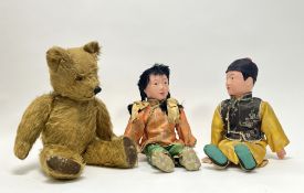 A pair of early 20thC Chinese papier-mache composition dolls, both in silk dress, together with a