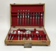 A Eickhorn oak canteen containing a part suite of stainless steel flatware to include five table