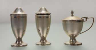 A Birmingham silver three piece condiment set comprising a mustard: h. x 7cm, pepperette: h. x 8cm