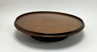 An early 20thC mahogany circular lazy Susan table centerpiece, on a circular base with raised border