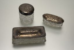 A late Victorian London silver mounted crystal two piece dressing table set with chased winged