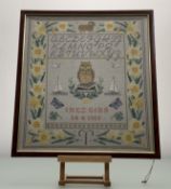 A 19thc School sampler by Inez Gibb, alphabet stick-work to top, with owl on books sailboats to
