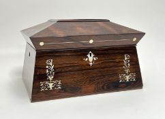 A Victorian rosewood sarcophagus-shaped tea caddy/jewellery box with mother of pearl inlay and