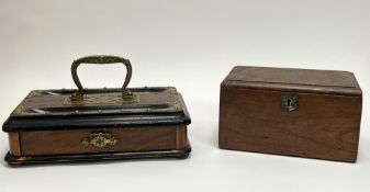 A rectangular wooden ink stand with central brass carrying handle and drawer with brass handle to