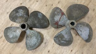 A pair of vintage bronze ship's propellers, each with four blades and natural patina: d. 80cm h.