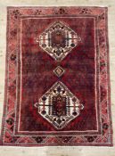 A hand-knotted Persian Shiraz carpet, central panel with twin medallions surrounded by all-over