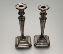 An Edwardain pair of Sheffield silver weighted tapered octagonal candlesticks on stepped bases -