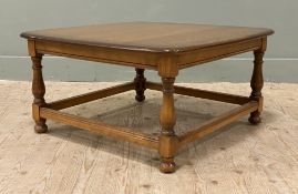 A mid-century elm coffee table, by Ercol. Square top with rounded edges raised on baluster