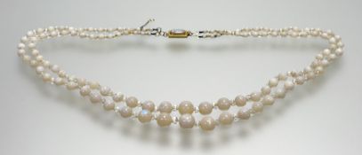 An early 20thc double stand graduated water opal necklace with crystal bead spacers and yellow metal