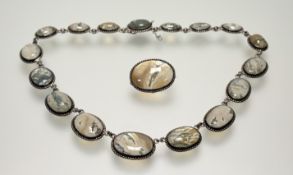 A late Victorian white metal graduated polished moss agate necklace with beaded borders and clip